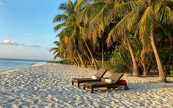 two sun loungers on a desert island