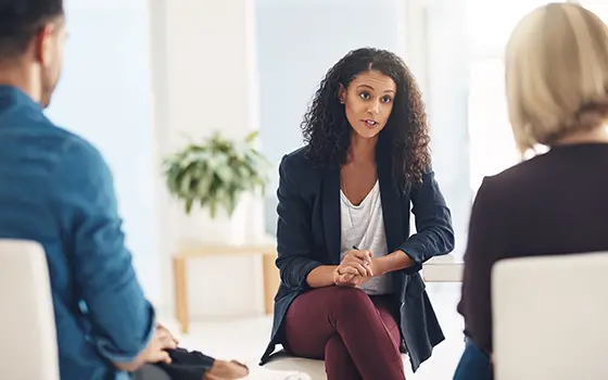 a man and a women speaking with a lawyer a man and a women speaking with a lawyer